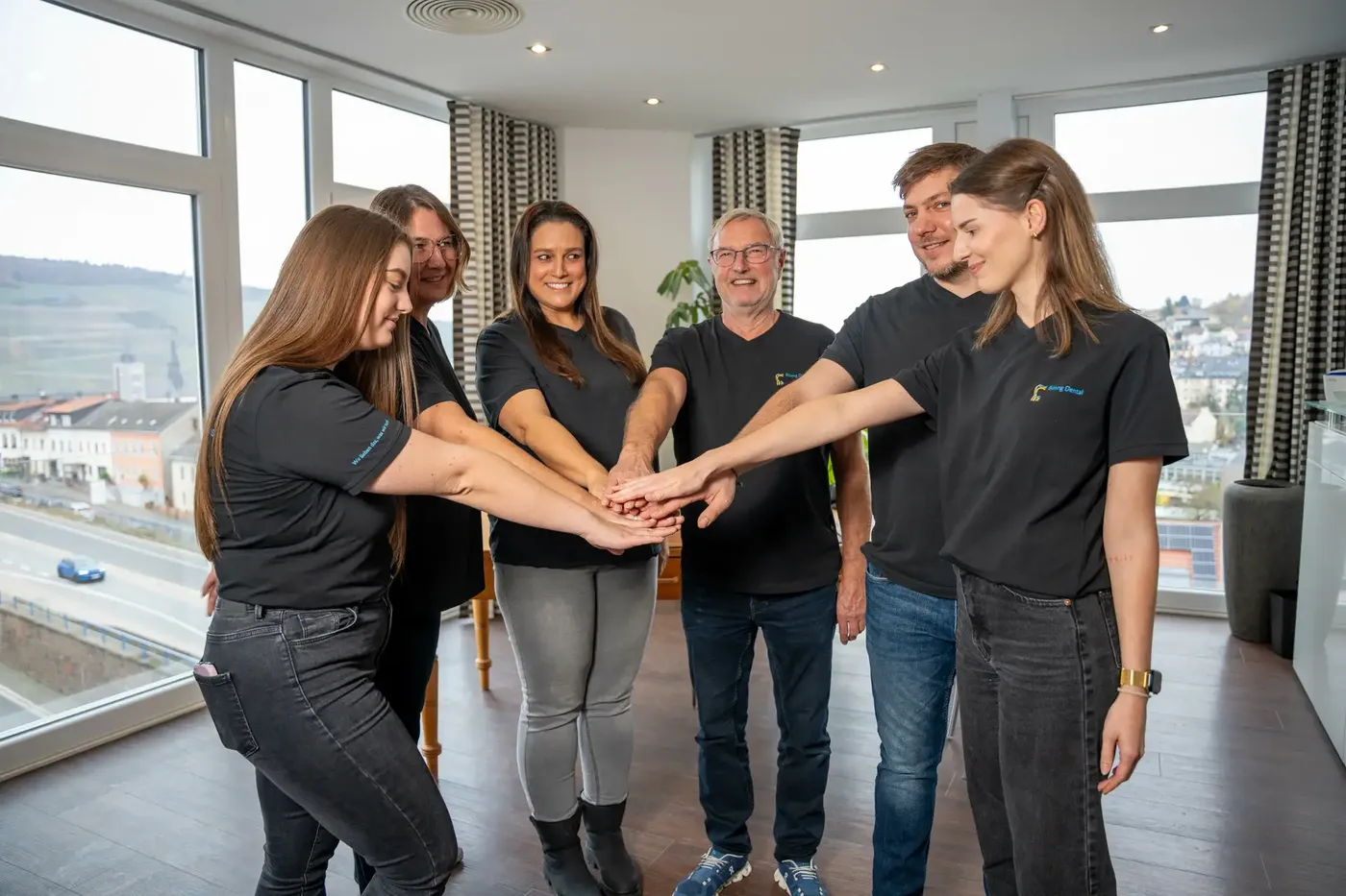 Das Team von Bösing Dental legt die Hände zusammen